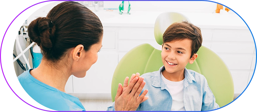 Friendly dental professional interacting with a young child patient in a welcoming environment