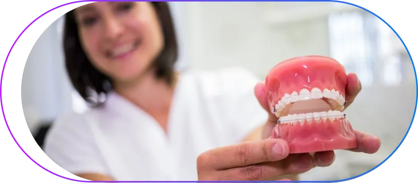 Dental professional demonstrating prosthetic dentures and dental restoration options