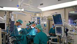 Modern operating room with surgical team performing advanced eye surgery